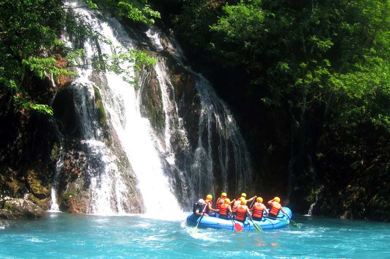 Pass by a beautiful waterfall during the rafting trip