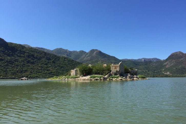 Beautiful view on mountain and old buildings, Skadar Lake