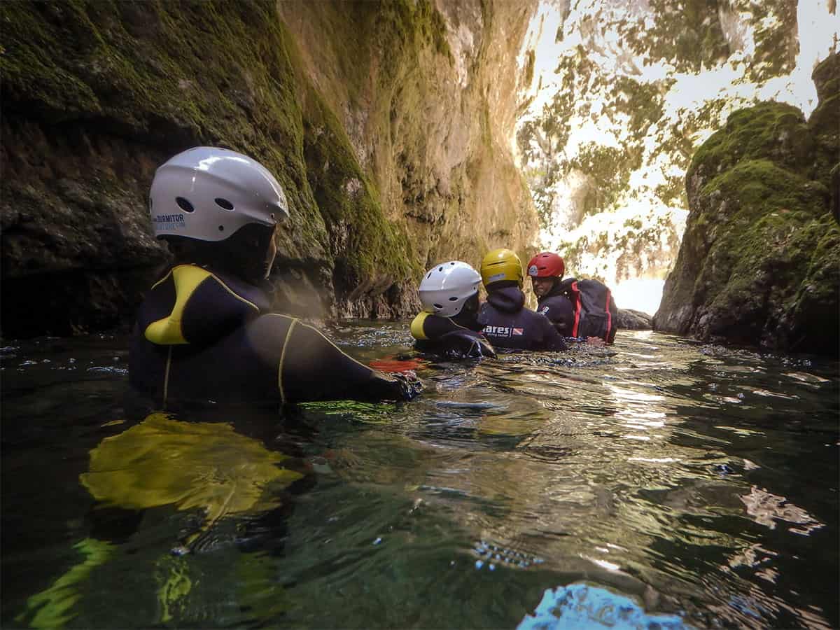 Group walking in the ice cold river at Canyon Nevidio