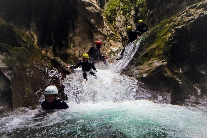 Tourists slide down water, Nevidio Canyon