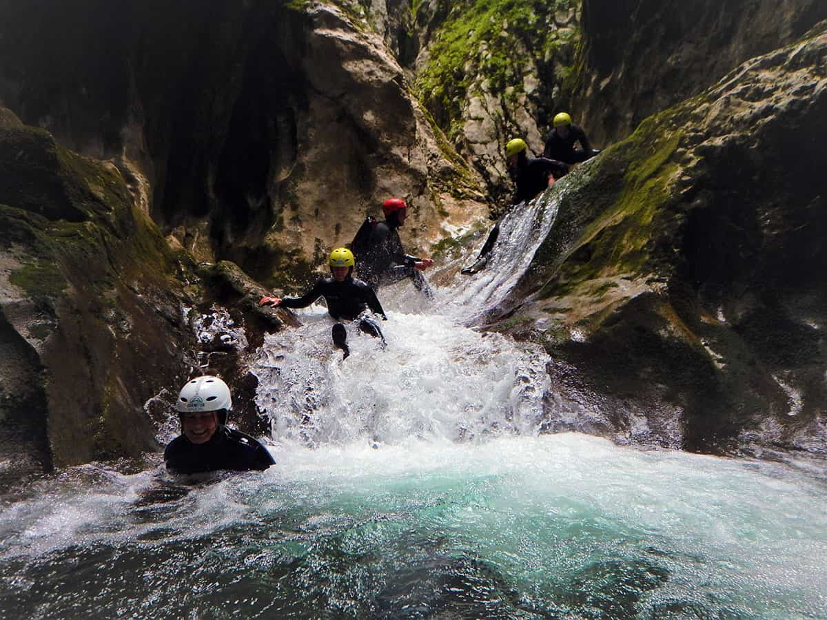 Tourists slide down water, Nevidio Canyon