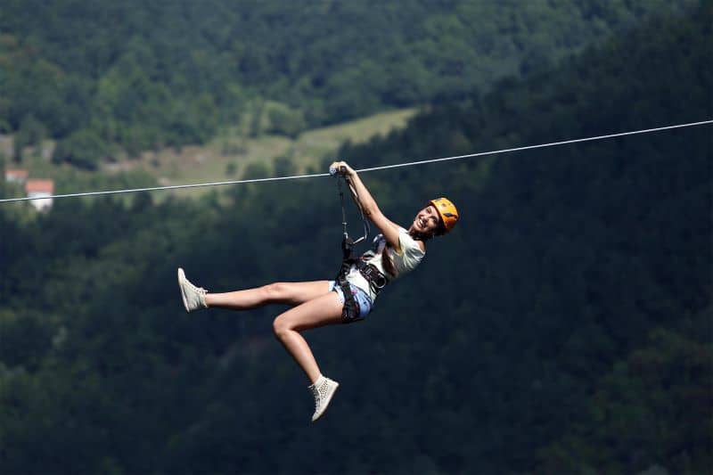 Happy girl on extreme zipline, Montenegro