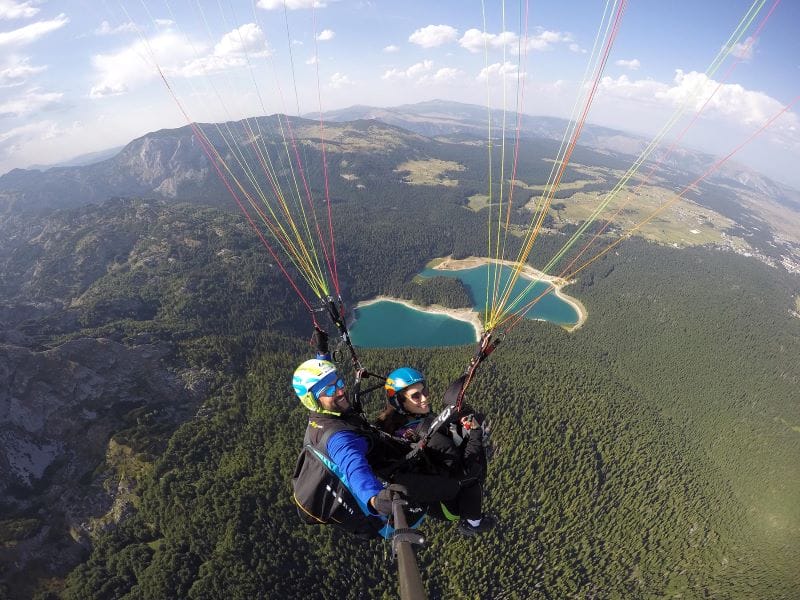Fly over beautiful Black Lake mountains tandem paragliding Savin Kuk with Montenegro Adventure