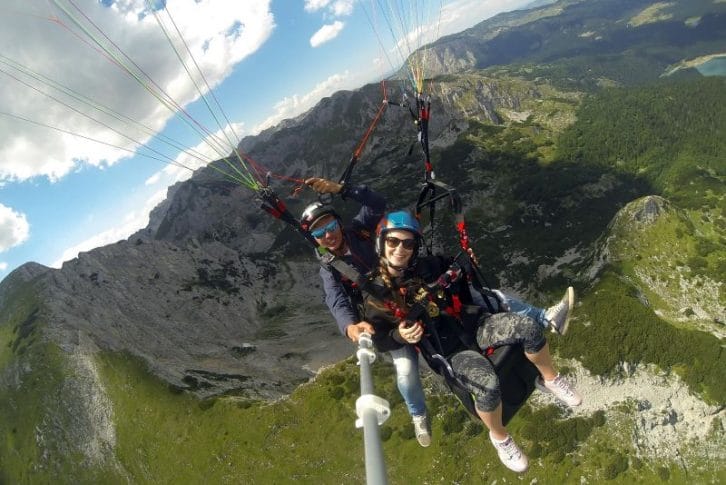 Stunning mountains background tandem paragliding Savin Kuk