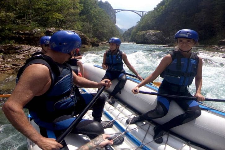 Rafting Tara splashing and laughing with the bridge in background