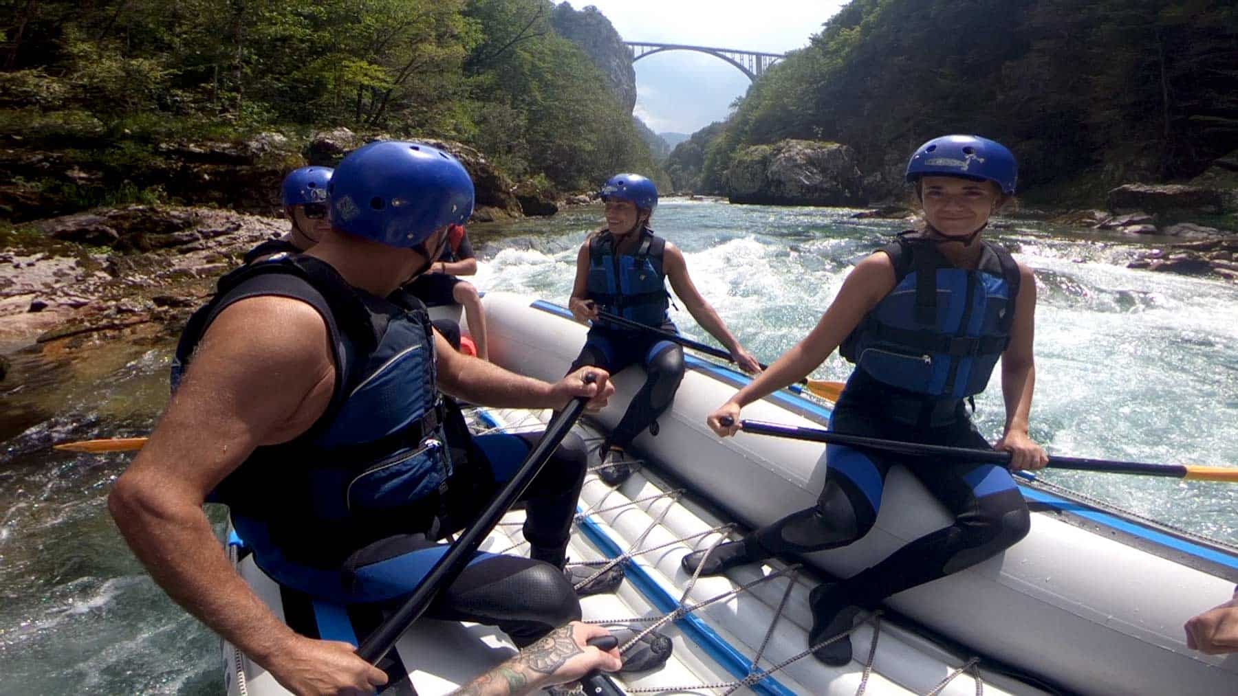 Rafting Tara splashing and laughing with the bridge in background