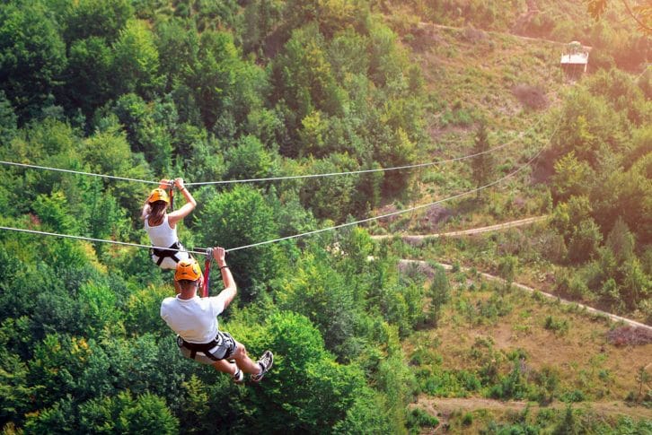 Two tourists ziplining together, Montenegro