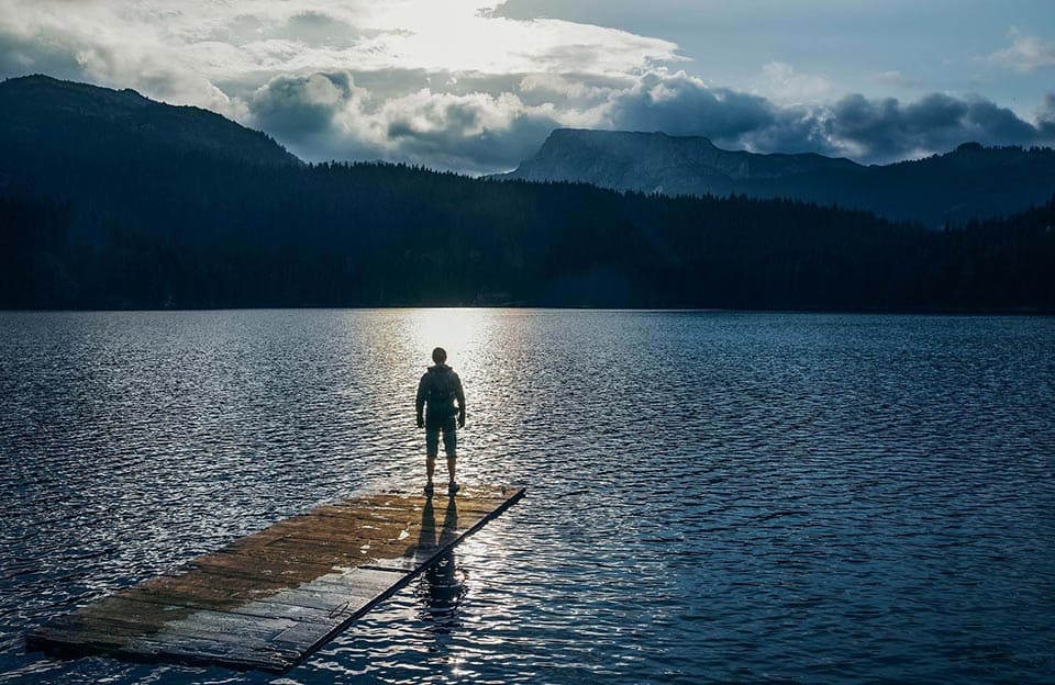 Lone trekker admiring the stunning view at Black Lake