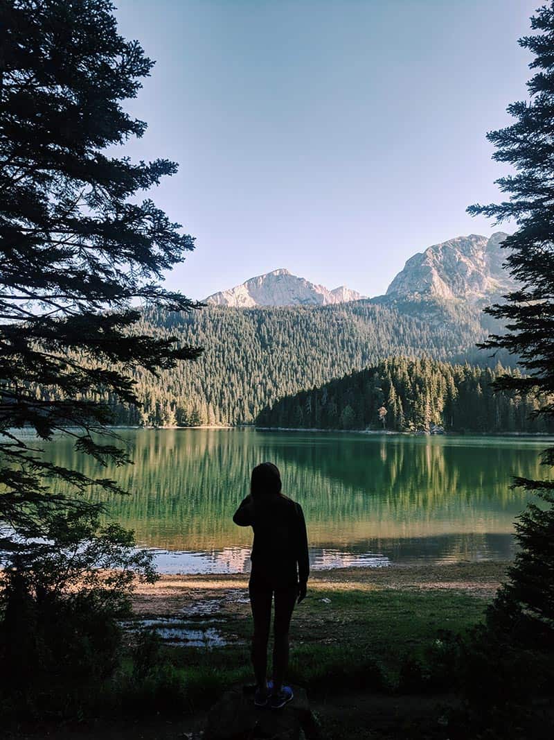 A girl standing Black Lake in Montenegro