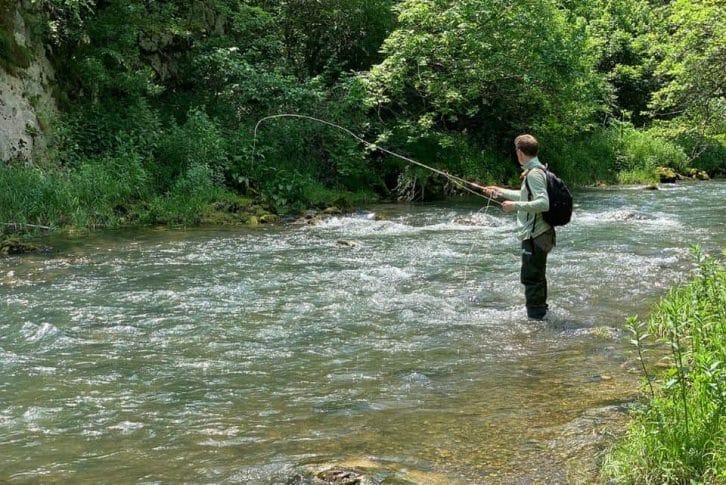 Standing in Tara river and fly fishing