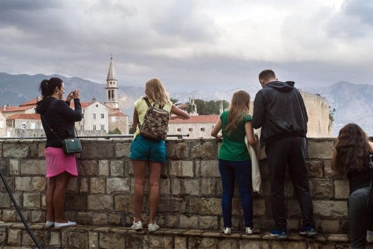 Tourist in Budva taking photos of the sea in Montenegro