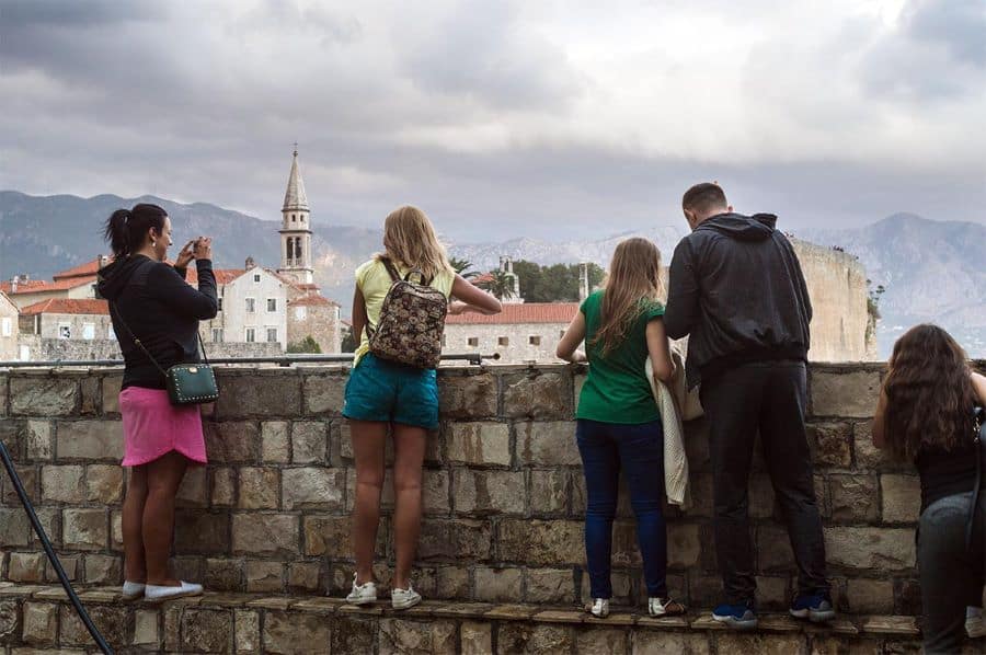 Tourist in Budva taking photos of the sea in Montenegro