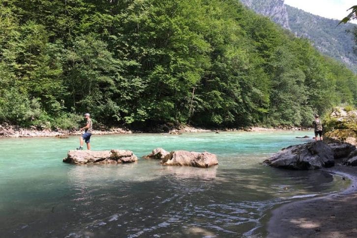 Two men fishing in stunning Tara river in Montenegro