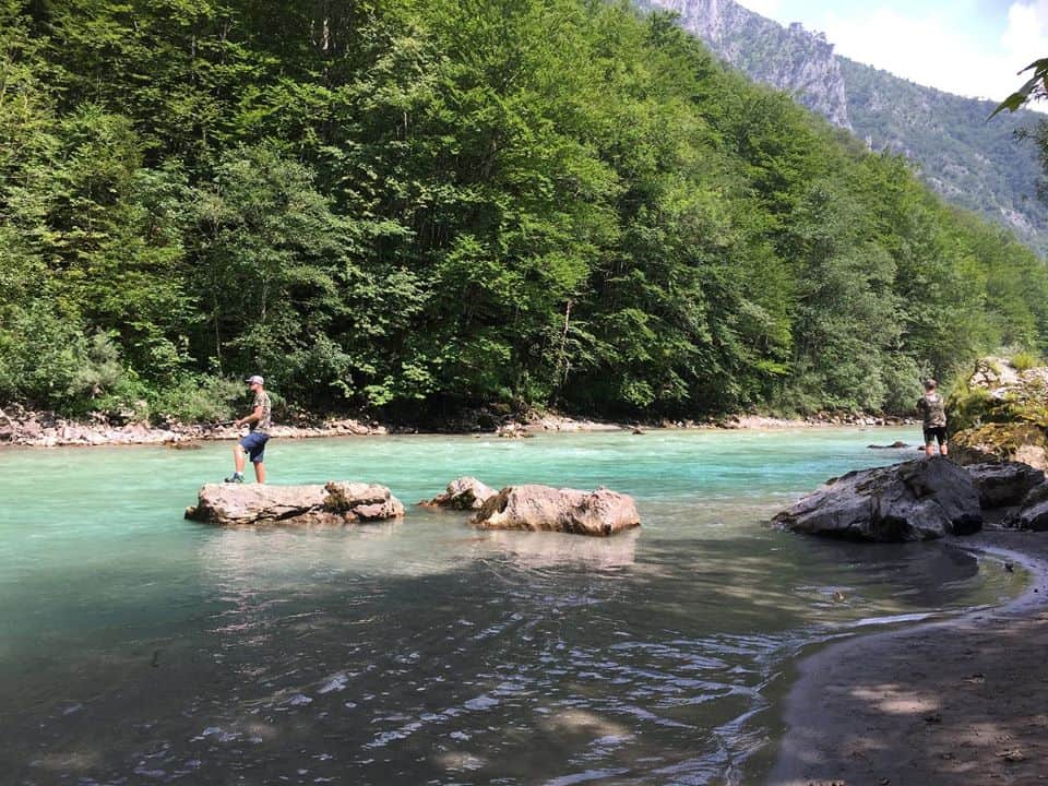 Two men fishing in stunning Tara river in Montenegro