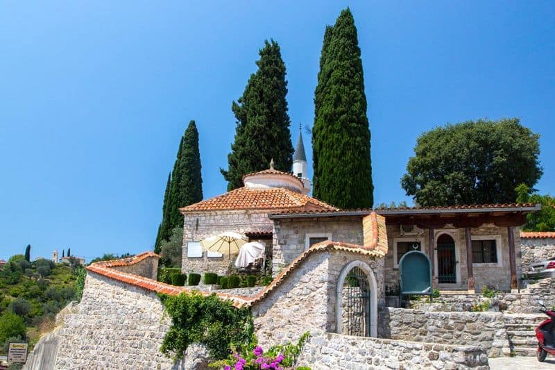 View of beautiful stone house with tiled roof in old town of Bar, Montenegro