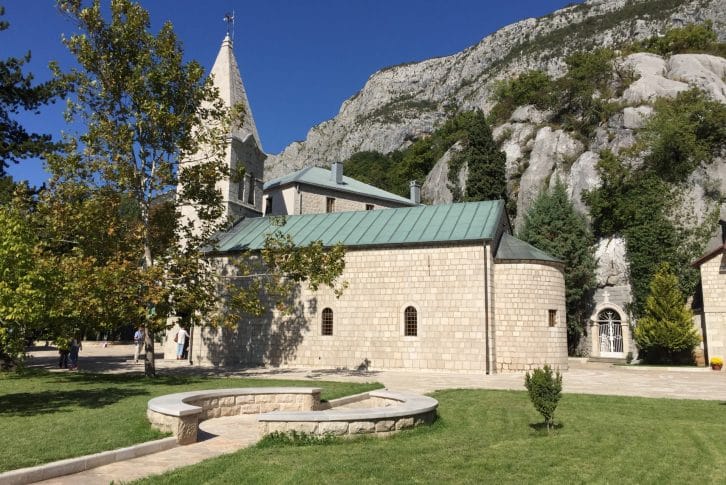 Ostrog Monastery - Holy Trinity Church green garden