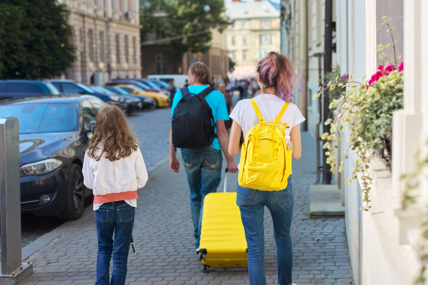 Father with kids carrying luggage arrival at Accommodarion Montenegro Adventure