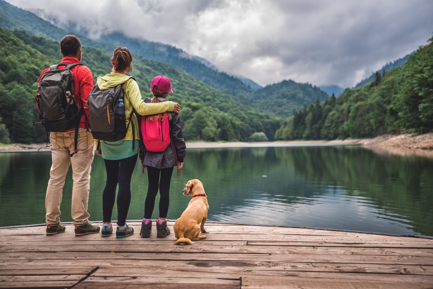 Family with dog standing on a pier Biograd Lake Montenegro
