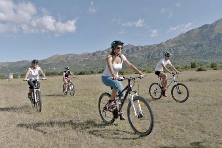 Biking through grazing on Konavle valley Adventure Camp