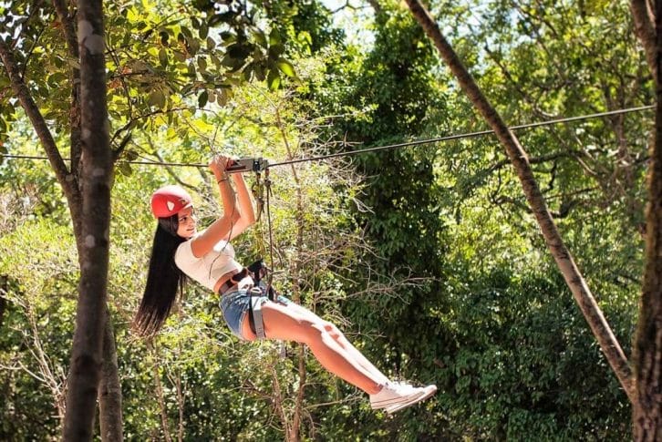 A girl fly on Zip-Line in Adventure Park at Konavle