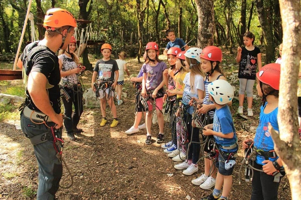 Preparations of a group of kids for zip line in Adventure Park at Konavle