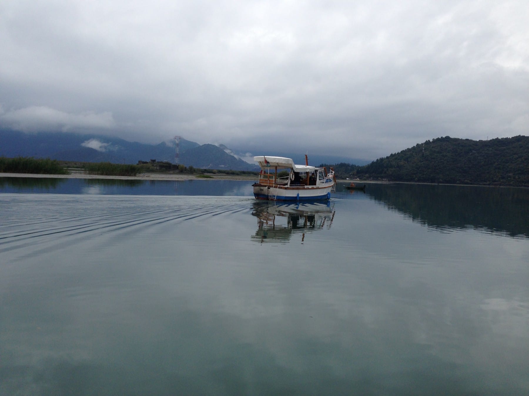 A boat cruise at Skadar Lake under a cloudy sky