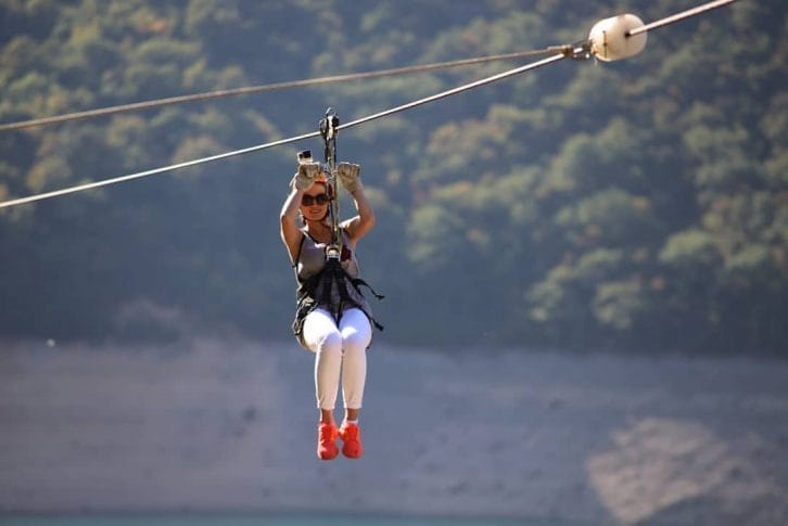 Zipline Piva Lake a girl across the lake