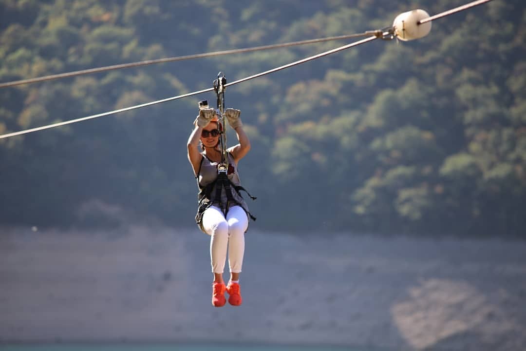 Zipline Piva Lake a girl across the lake