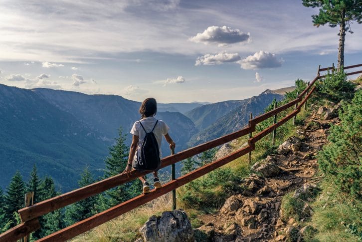 Hiker woman enjoying breathtaking views in Durmitor National Park, Montenegro