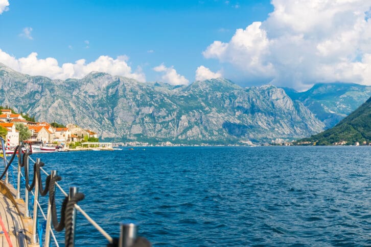 ourists sailed on the yacht past the city of Perast in the Boka Bay of Kotor.