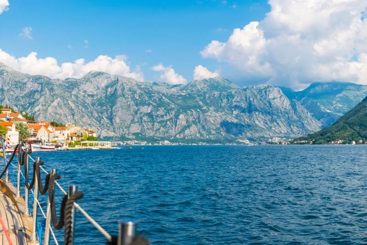 ourists sailed on the yacht past the city of Perast in the Boka Bay of Kotor.