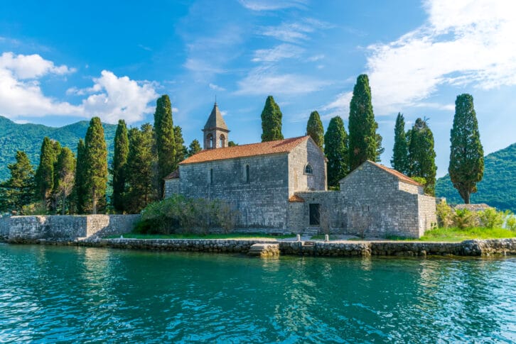 The yacht sails near the picturesque island of St. George in the Bay of Kotor.