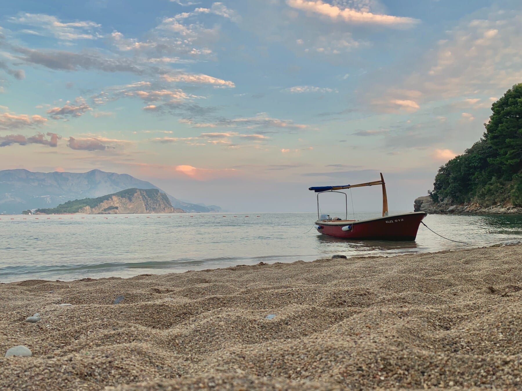 budva-montenegro-boat-achored-at-the-beach-with-the-view-of-island-sveti-nikola-montenegro-adventure