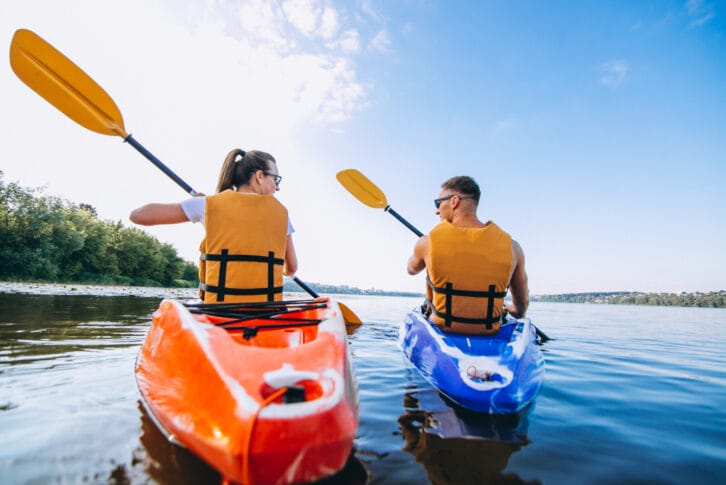 Couple together kayaking on the sea