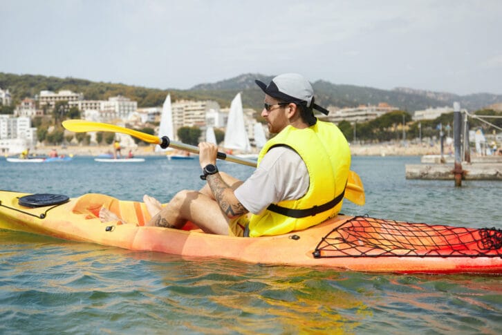 Close-up shot of kayaking youngster in a canoe