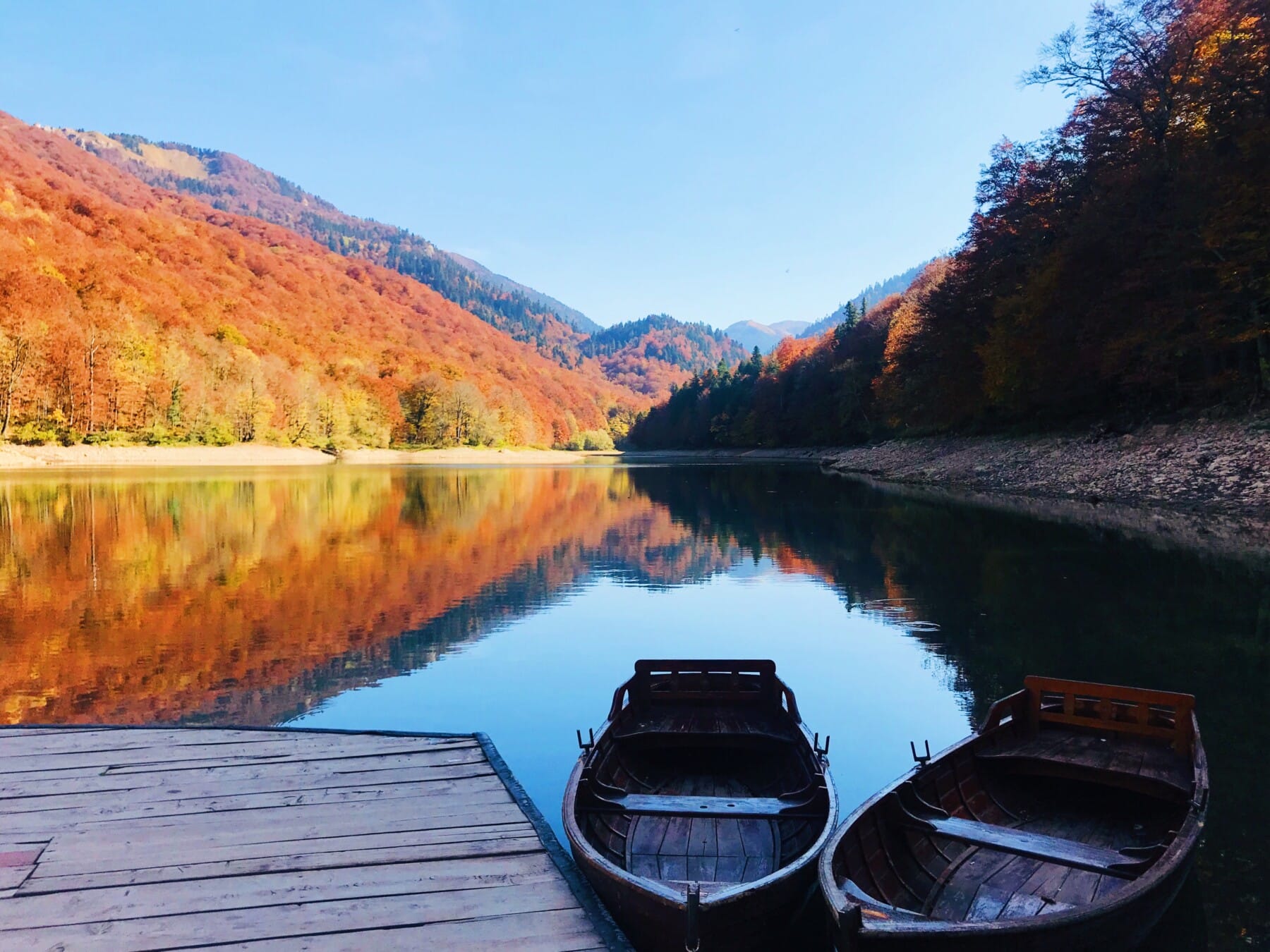 Boats on the reflective Biograd lake in NP Biogradska gora in Montenegro