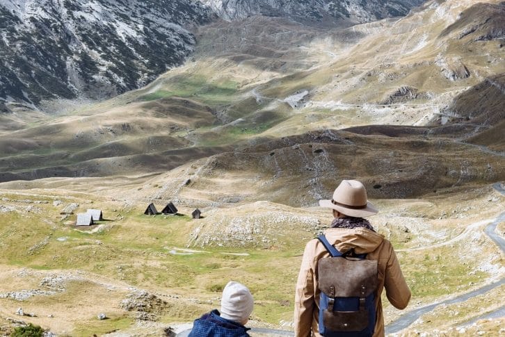 Father and son travel together in autumn mountains Durmitor, Montenegro