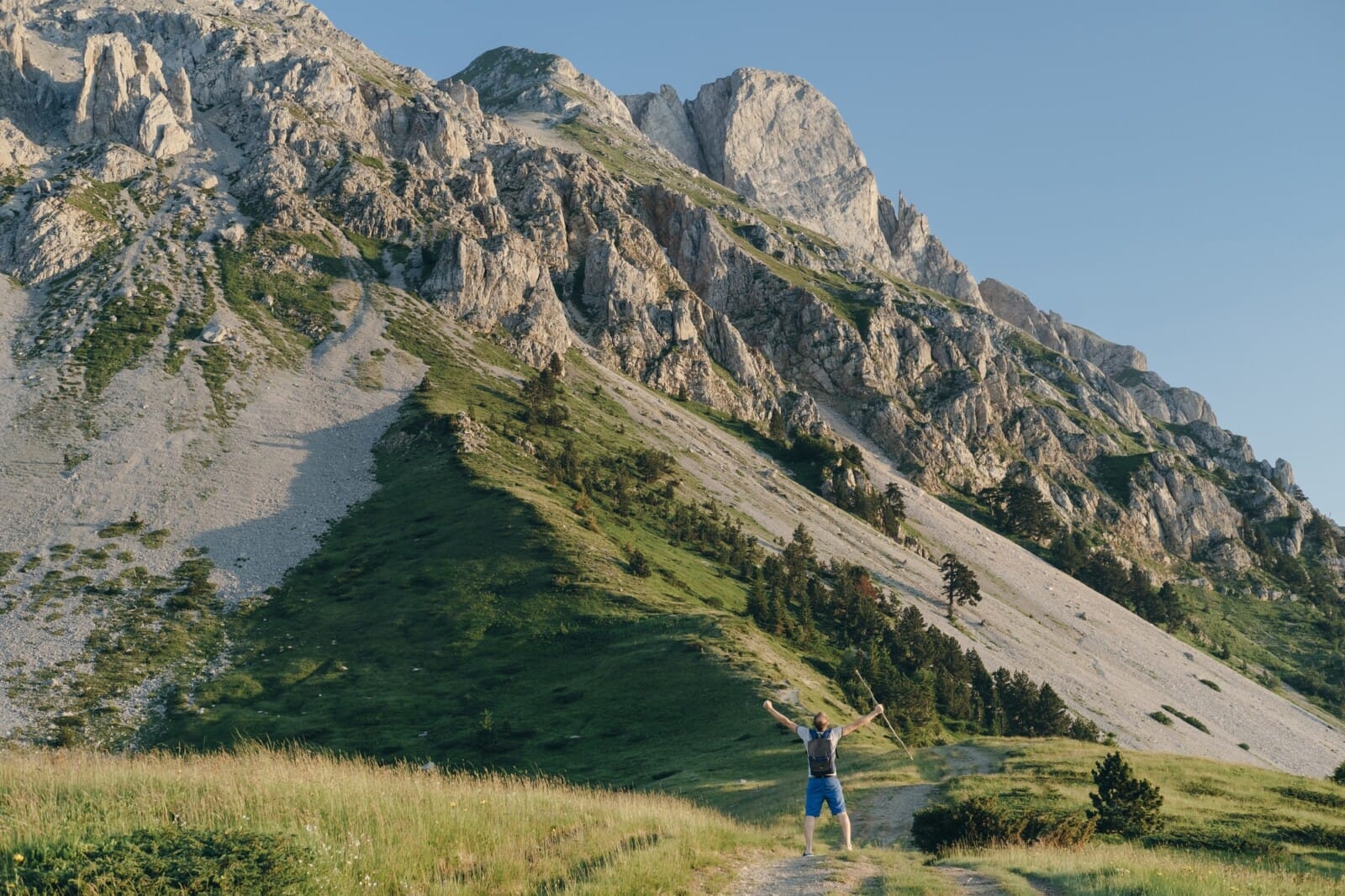 Man traveler raised his hands up against the background of the mountain, Montenegro,