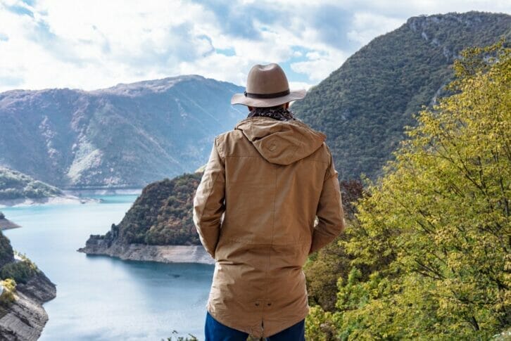 Traveler on the background The famous Piva Canyon with its fantastic reservoir.